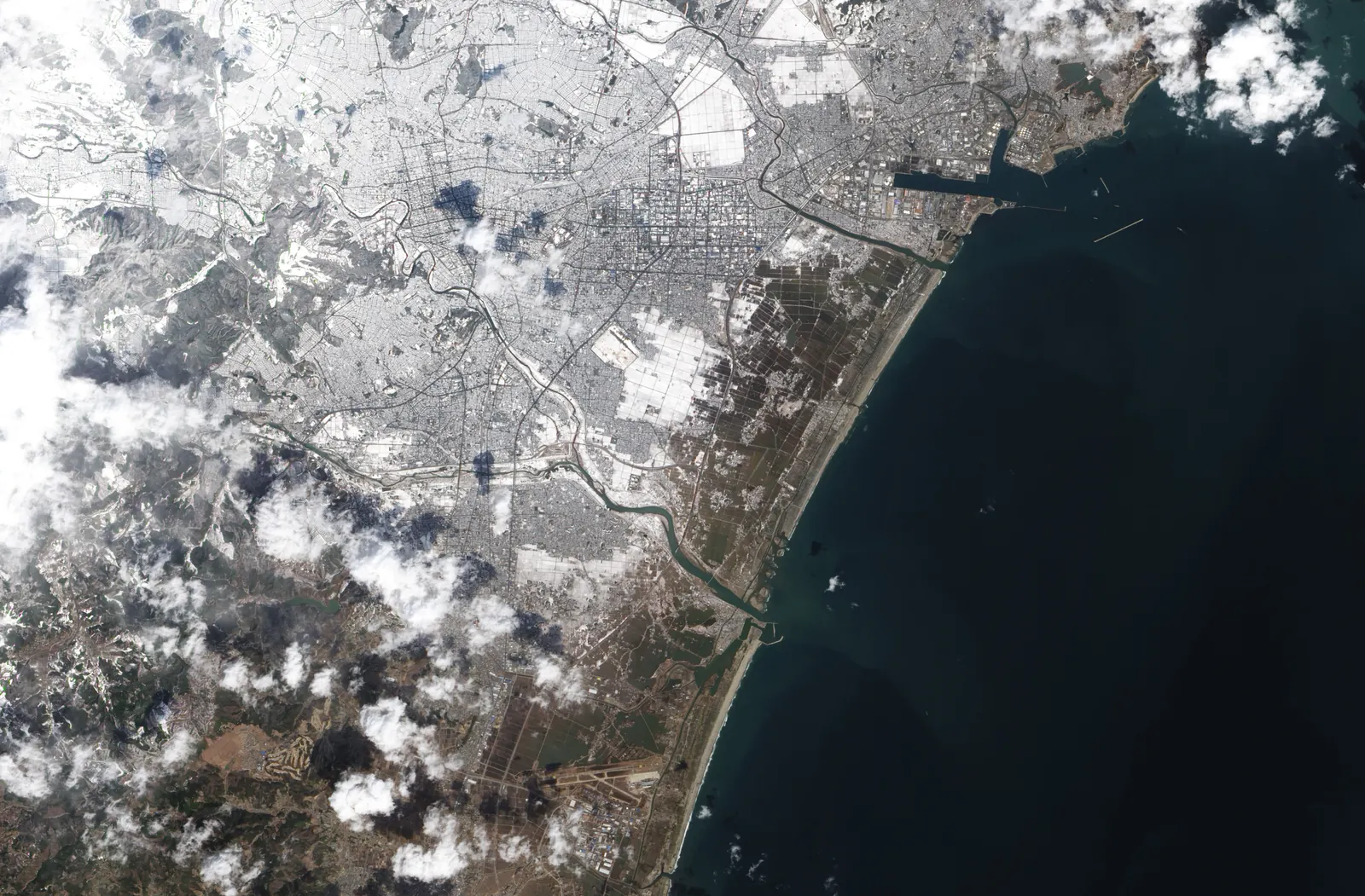 Satellite view of flooded coastal fields near Sendai after the 2011 tsunami.